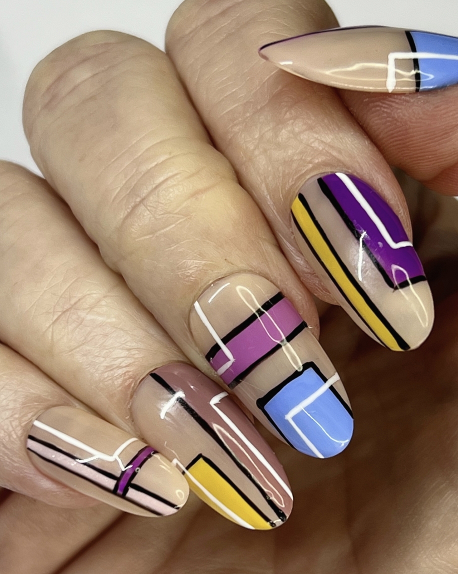 Picture of vibrant, multi-color painted nails on hand model