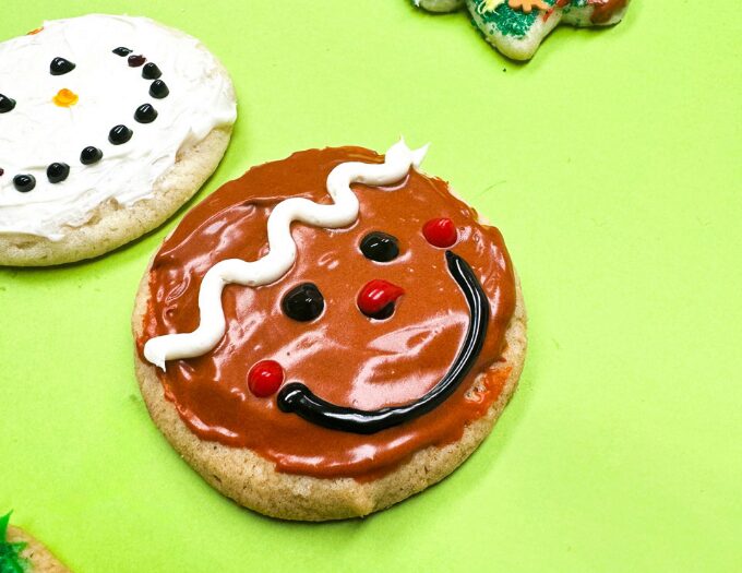 image of decorated smiley round cookie with green backgound